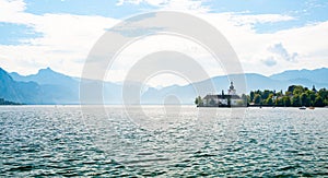 Schloss Ort castle near Traunsee, Austria. View of ancient castle with long bridge over lake. Famous tourist destination
