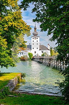 Schloss Ort castle near Traunsee, Austria. View of ancient castle with long bridge over lake. Famous tourist destination