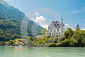 Schloss Seeburg. Seeburg castle was built on peninsula surrounded by the teal coloredwaters of lake Brienz. Iseltwald