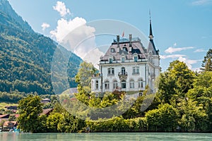 Schloss Seeburg. Seeburg castle was built on peninsula surrounded by the teal coloredwaters of lake Brienz. Iseltwald