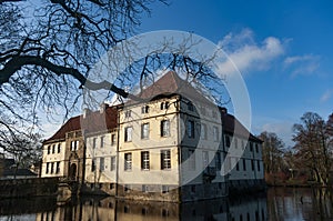 Schloss Strunkede grom the bare branches on a sunny morning in Herne photo