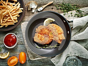 Schnitzel on cooking pan photo