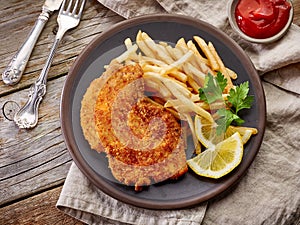 Schnitzel and fried potatoes