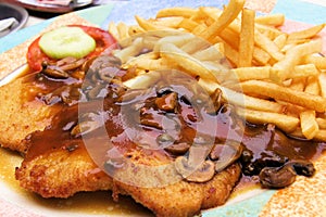 Schnitzel with muchroom sauce photo