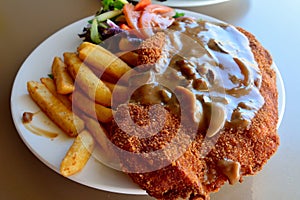 Schnitzel with salad, mushroom sauce