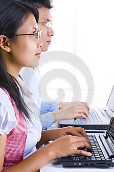 Scholars listening and typing in class photo