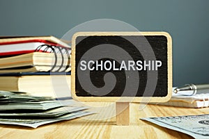 Scholarship concept. Notebooks and money for education photo
