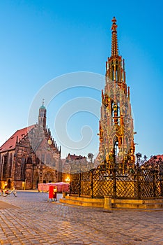 Schoner Brunnen and Frauenkirche in German town Nurnberg during