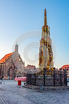 Schoner Brunnen and Frauenkirche in German town Nurnberg during