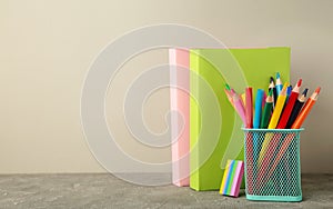 School accessories with books on grey background. Back to school concept