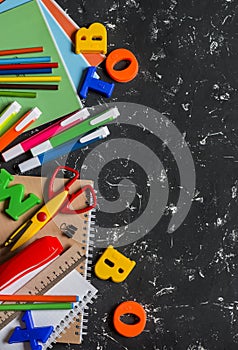 School accessories on a dark background. Top view