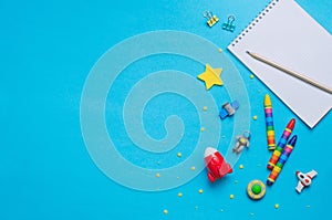 School accessories and space toys on blue background