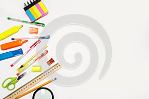 School accessories on a white background. stationery. back to school. concept of education. desk. color pens, pencils, ruler, alar