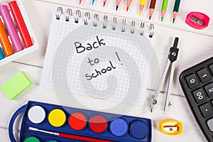 School accessories on white boards, back to school concept