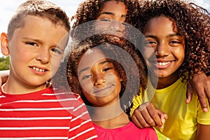 School age boy and girls in park group portrait