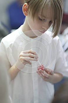 School age boy holding a jar of gel dentifrice photo