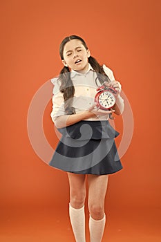 School alarm. Happy girl hold alarm clock counting for lunch time. School time. time to go to school. Children education