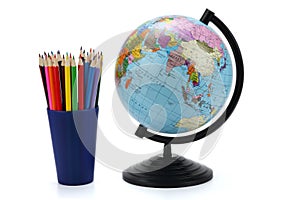 School background. Globe with colored pencils isolated on white background