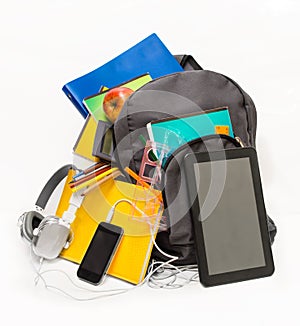 School backpack with school supplies and a tablet with headphon