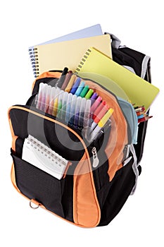 School bag full with pens and books, isolated on white background