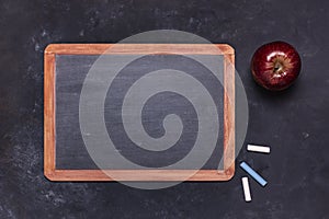 School blackboard with chalks and red apple