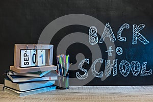 School blackboard with text `Back to school` . September and education concept