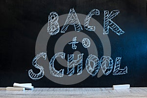 School blackboard with text `Back to school` . September and education concept