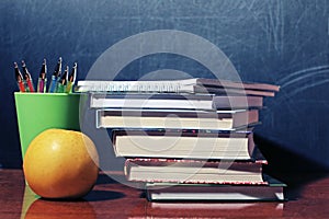 School books and apple photo