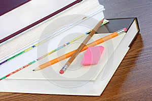 School books, stacked, with pencils