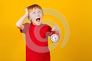 School boy with alarm clock shouting. Shocked little student. Seasonal discounts, sale concept. Mock up with copy space
