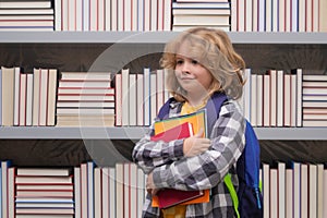 School boy with books in library. Nerd pupil. Clever child from elementary school with book. Smart genius intelligence