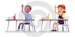 School boy, girl at desk raising hands to answer questions