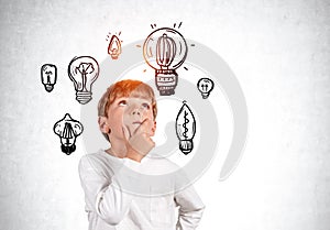 School boy pensive portrait looking up, light bulb sketches