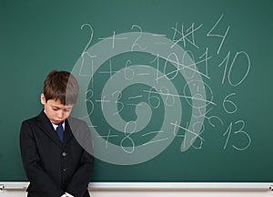 School boy solve math on school board