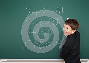 School boy solve math on school board