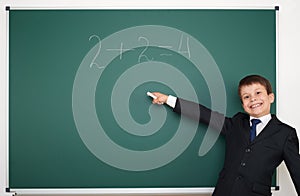 School boy solve math on school board