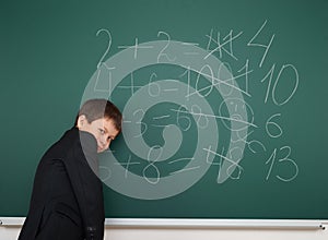 School boy solve math on school board