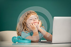 School boy studying math during online lesson in classroom, online education. School boy dreaming on lesson.