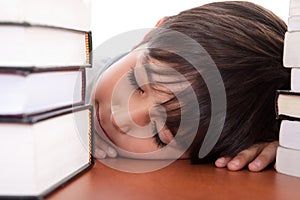 School boy tired of studying sleeping