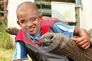School boy visits the giant tortoises on St Helena photo