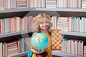School boy with world globe and chess, childhood. School and kids. Cute blonde child with a book learning. Knowledge day