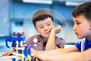 School Boys playing with construction set.