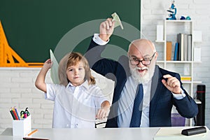 School break. Teacher with pupil with airplanes. Education, teachering, learning.