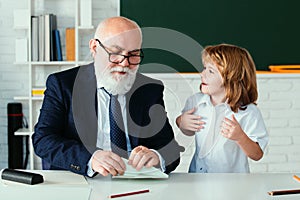 School break with teacher. Schoolboy with airplanes. Education, teachering, learning. Pupil in classroom.