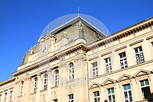 School building with clocks and flags