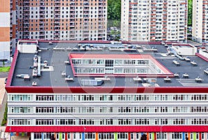 School building exterior modern apartment building mixed-use urban multi-family residential district area development.