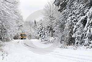 School Bus Drives On Snow Covered Rural Road