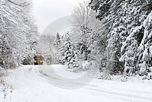 School Bus Drives On Snow Covered Rural Road photo