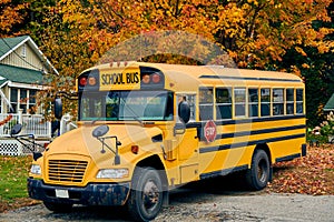 School bus on driveway at autumn