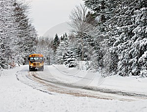 School Bus Driving Down A Snow Covered Rural Road - 1